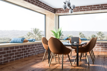 Brick dining room, brown chairs