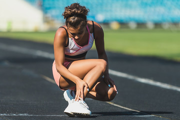 portrait of sporty woman having ankle injury in running track., Healthcare and sport concept