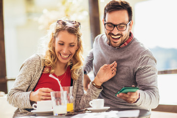  Beautiful loving couple sitting in a cafe enjoying in coffee and conversation. Love, romance, dating