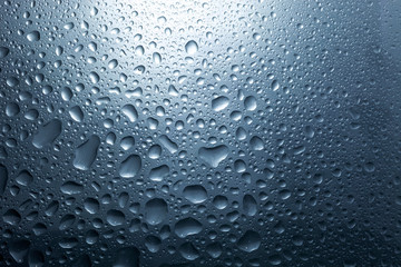 Water drops on dark wall and light, water drop for background and design.