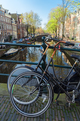 Fototapeta premium Romantic scenery with bicycles at one of the canals in Amsterdam old town, Netherlands