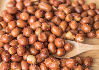 roasted peanuts on wooden background.
