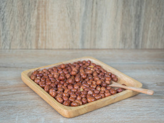roasted peanuts on wooden background.