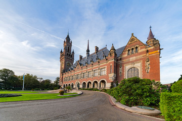 Fototapeta na wymiar THE HAGUE, 26 September 2018 - Sunrise at the Peace Palace, seat of the International Court of Justice, view from the peaceful garden with flowers around the building