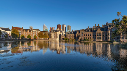 Reflection of the Buitenhof, Binnenhof buildings, Dutch parliament campus under a clear blue sky in...