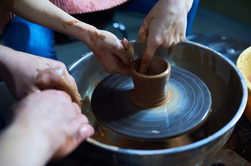 Master class on modeling of clay on a potter's wheel In the pottery workshop