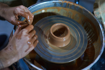 Fototapeta premium Master class on modeling of clay on a potter's wheel In the pottery workshop
