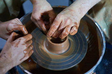 Master class on modeling of clay on a potter's wheel In the pottery workshop