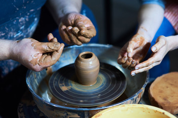 Master class on modeling of clay on a potter's wheel In the pottery workshop