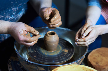 Master class on modeling of clay on a potter's wheel In the pottery workshop