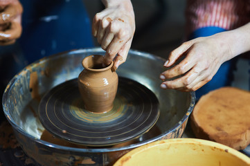 Master class on modeling of clay on a potter's wheel In the pottery workshop
