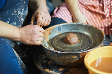 Master class on modeling of clay on a potter's wheel In the pottery workshop