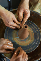 Master class on modeling of clay on a potter's wheel In the pottery workshop