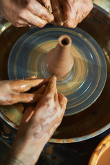 Master class on modeling of clay on a potter's wheel In the pottery workshop