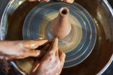 Master class on modeling of clay on a potter's wheel In the pottery workshop