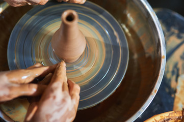 Master class on modeling of clay on a potter's wheel In the pottery workshop