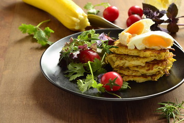 Pancakes with zucchini, eggs and vegetables, healthy breakfast, copy space