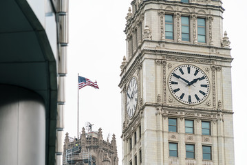 Fototapeta na wymiar Clocktower in Downtown Chicago with American Flag