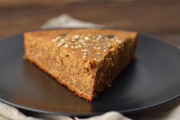piece of pecan pie on a black plate at an angle of 45