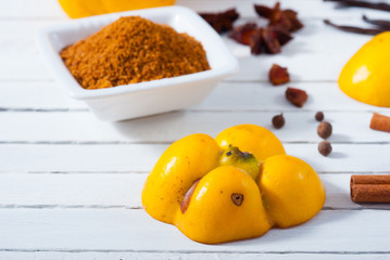 quince jelly and ingredients on white wooden table background