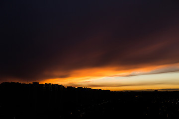 Orange sunset in the city. City landscape. Silhouette