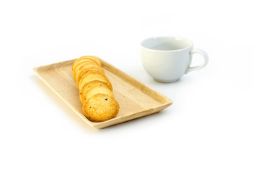 arrange cookie on wood plate with a cup of coffee in white background