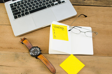 top view of working equipment, computer, book and chart pater