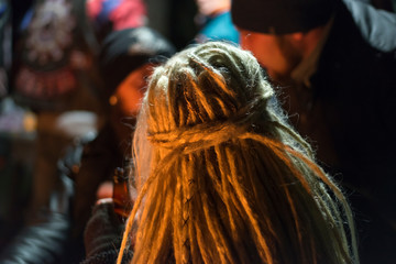 Girl with white dreadlocks at night, close-up