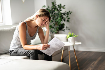 Blonde Beautiful woman stressed because of bills