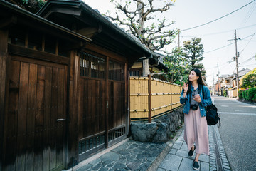 elegant lady pointing at Japanese building
