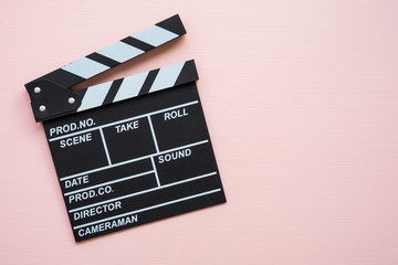 Cinema clapperboard on pink wooden background - Movie entertainment concept