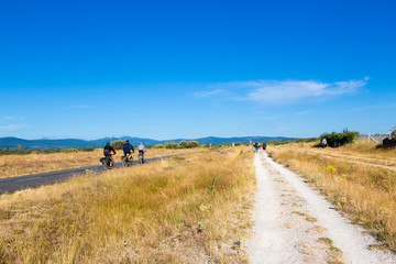 Obraz premium Camino de Santiago (Spain) - Pilgrims and bikers along the way of St.James, in the spanish meseta