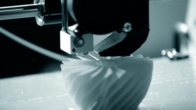 3D printer working close up. Automatic three dimensional 3d printer performs plastic. Modern 3D printer printing an object from the hot molten. Concept progressive additive technology for 3d printing.