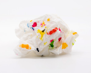 Used tissue paper and colorful of art on white background. Crumpled fabric cleaner and abstract shape.