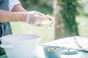 catering waiter serving food on white plate outdoors