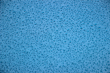 Fototapeta na wymiar Rainy stains on a blue background