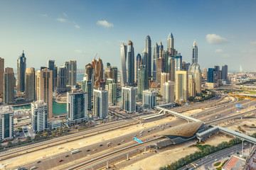 Naklejka na ściany i meble Aerial daytime skyline of Dubai Marina, UAE, with skyscrapers in the distance. Scenic travel background.