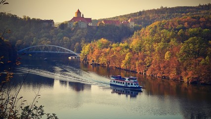 Castle Veveri - City of Brno, Czech Republic - Europe. Beautiful autumn landscape with castle. Brno dam with boat and sunset at the golden hour. Autumn season October. - obrazy, fototapety, plakaty