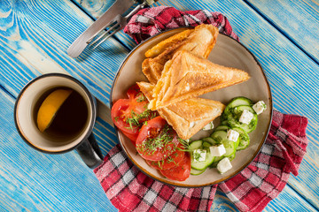 Sandwiches with cheese, tomatoes and cucumber.