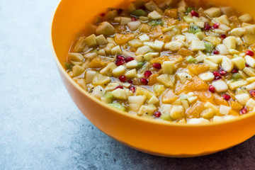 Homemade Healthy Organic Fruit Salad in Yellow Plastic Bowl.