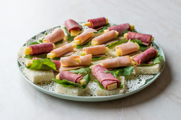 Canape Ham Wrapped with Cheese and Greens in Round Plate.