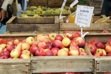 Fresh apples in wooden boxes on sale at the city market