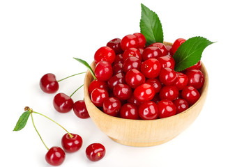 ripe juicy cherry berries with leaves in a plate
