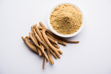 Ashwagandha / Aswaganda OR Indian Ginseng is an Ayurveda medicine in stem and powder form. Isolated on plain background. selective focus