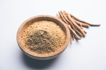 Ashwagandha / Aswaganda OR Indian Ginseng is an Ayurveda medicine in stem and powder form. Isolated on plain background. selective focus