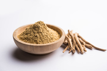 Ashwagandha / Aswaganda OR Indian Ginseng is an Ayurveda medicine in stem and powder form. Isolated on plain background. selective focus