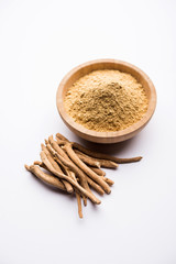 Ashwagandha / Aswaganda OR Indian Ginseng is an Ayurveda medicine in stem and powder form. Isolated on plain background. selective focus