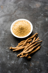 Ashwagandha / Aswaganda OR Indian Ginseng is an Ayurveda medicine in stem and powder form. Isolated on plain background. selective focus