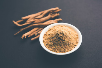 Ashwagandha / Aswaganda OR Indian Ginseng is an Ayurveda medicine in stem and powder form. Isolated on plain background. selective focus