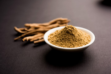 Ashwagandha / Aswaganda OR Indian Ginseng is an Ayurveda medicine in stem and powder form. Isolated on plain background. selective focus